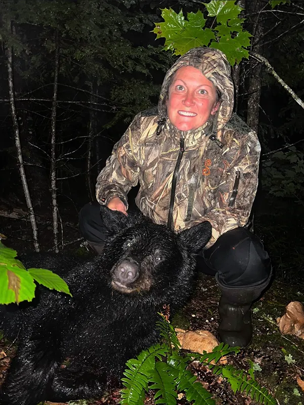 Female hunter with black bear