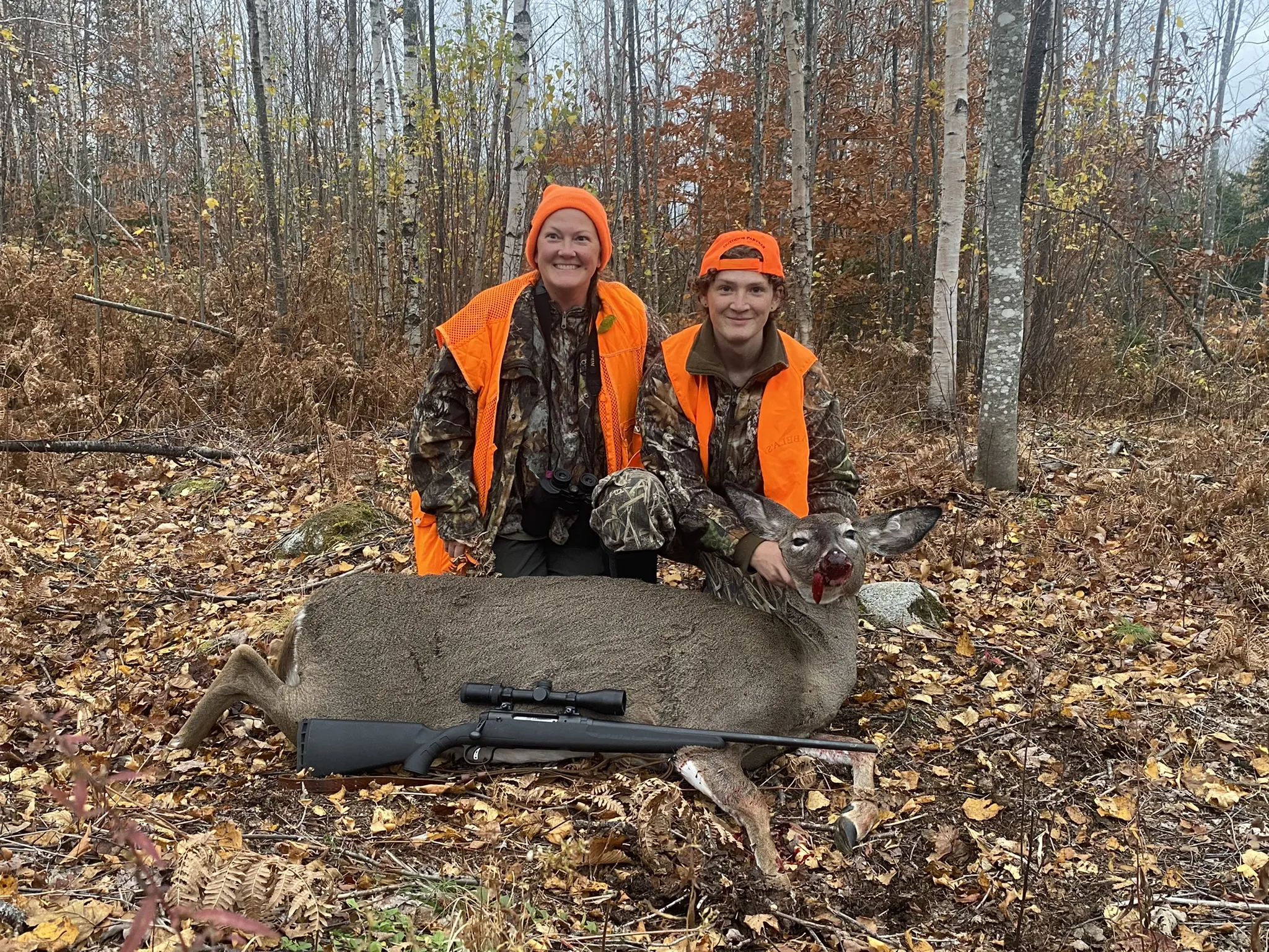 Youth hunter and guide with harvested doe deer